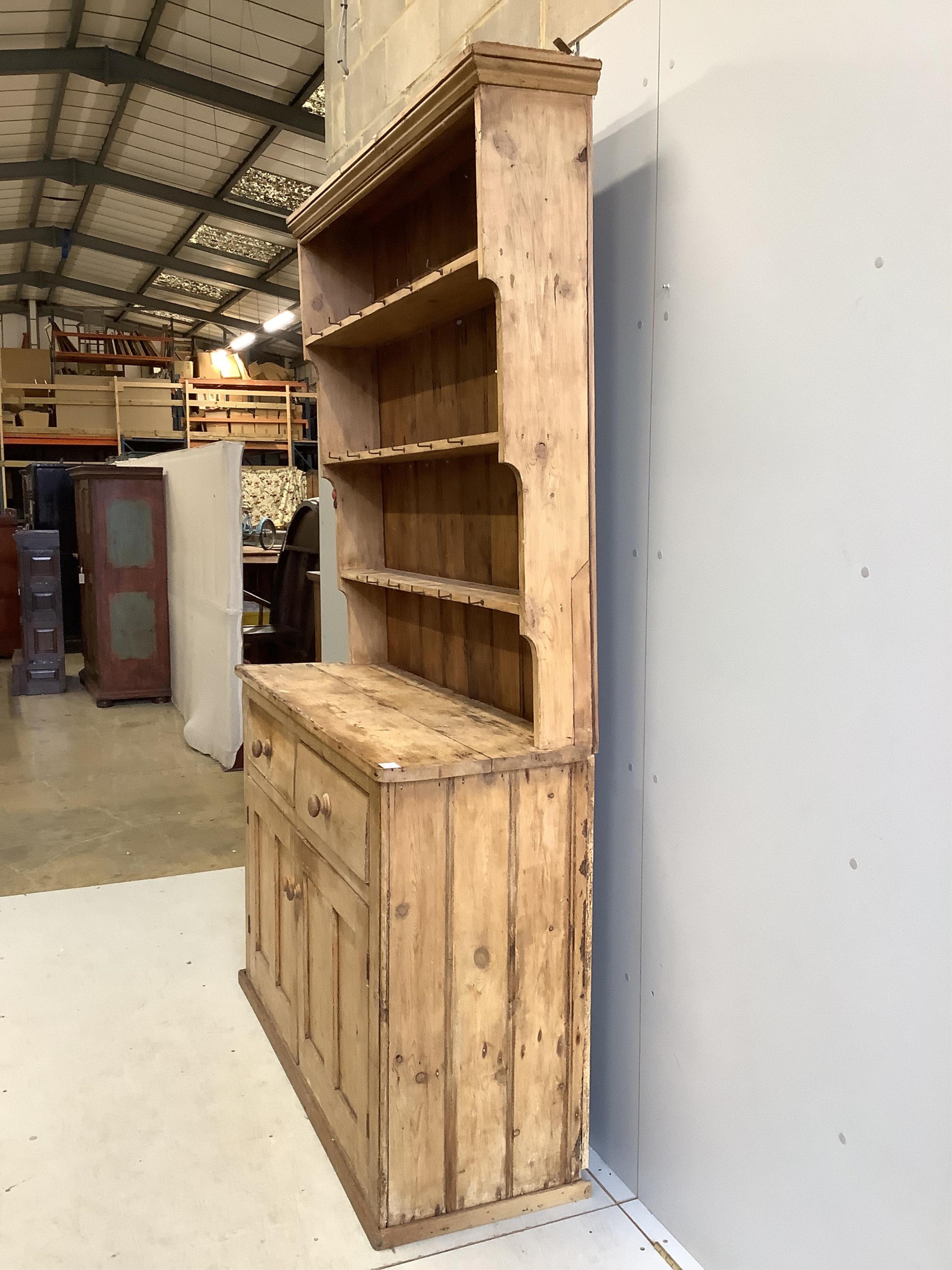 A Victorian pine dresser with boarded rack, width 140cm, depth 46cm, height 122cm. Condition - poor